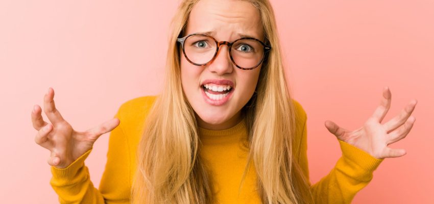 Adorable teenager woman screaming with rage.